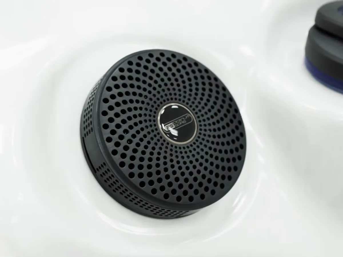 The filter and skimmer lid inside a white hot tub shell