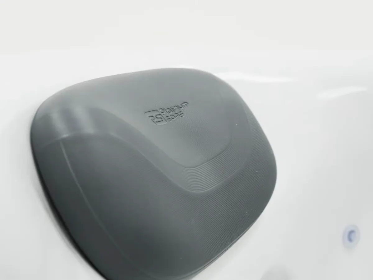 Grey Platinum Spas headrest pillow on a white hot tub shell