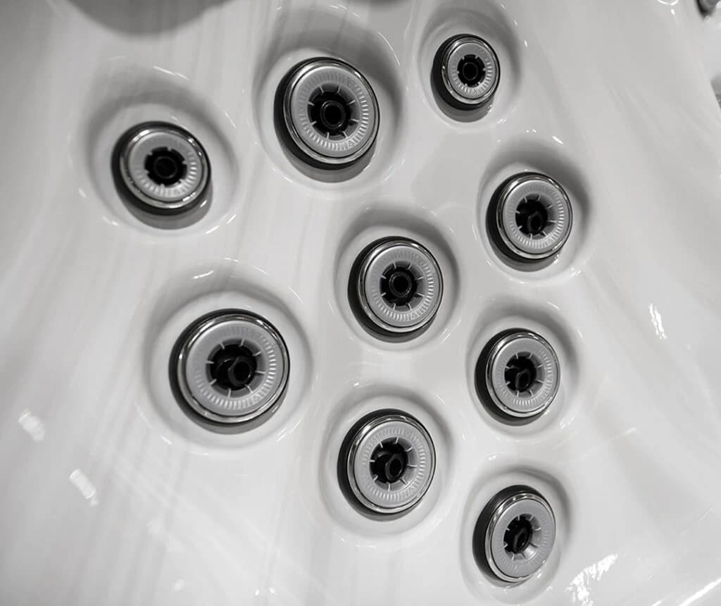 Close-up of stainless hydrotherapy jets set into a white Vita Spa hot tub seat